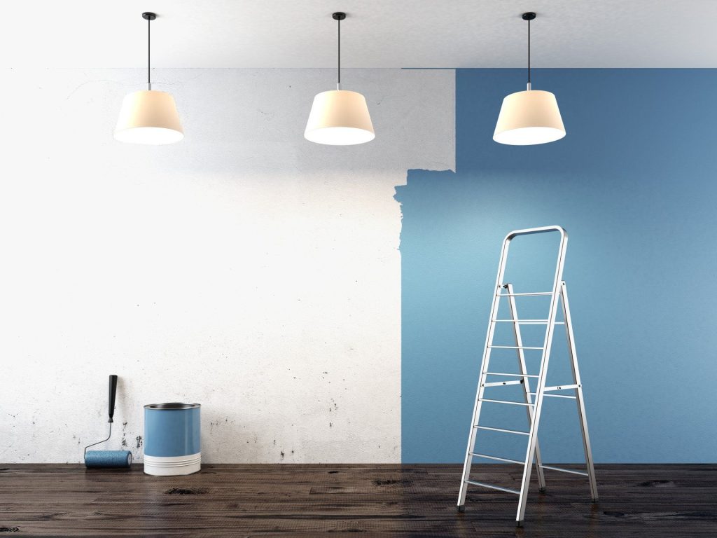 A blue wall is in the background of a ladder.