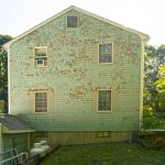 A building with a green roof and a photo gallery.