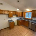 A kitchen gallery with wooden cabinets.