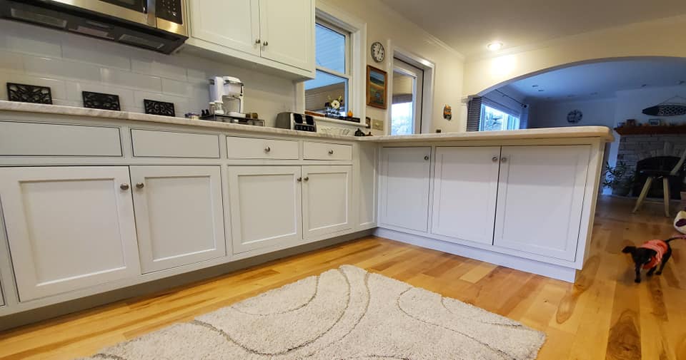 A house painting gallery showcasing a kitchen with white cabinets.