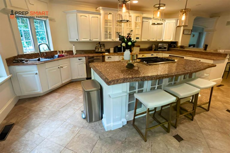 A kitchen with granite counter tops and dark cabinet.