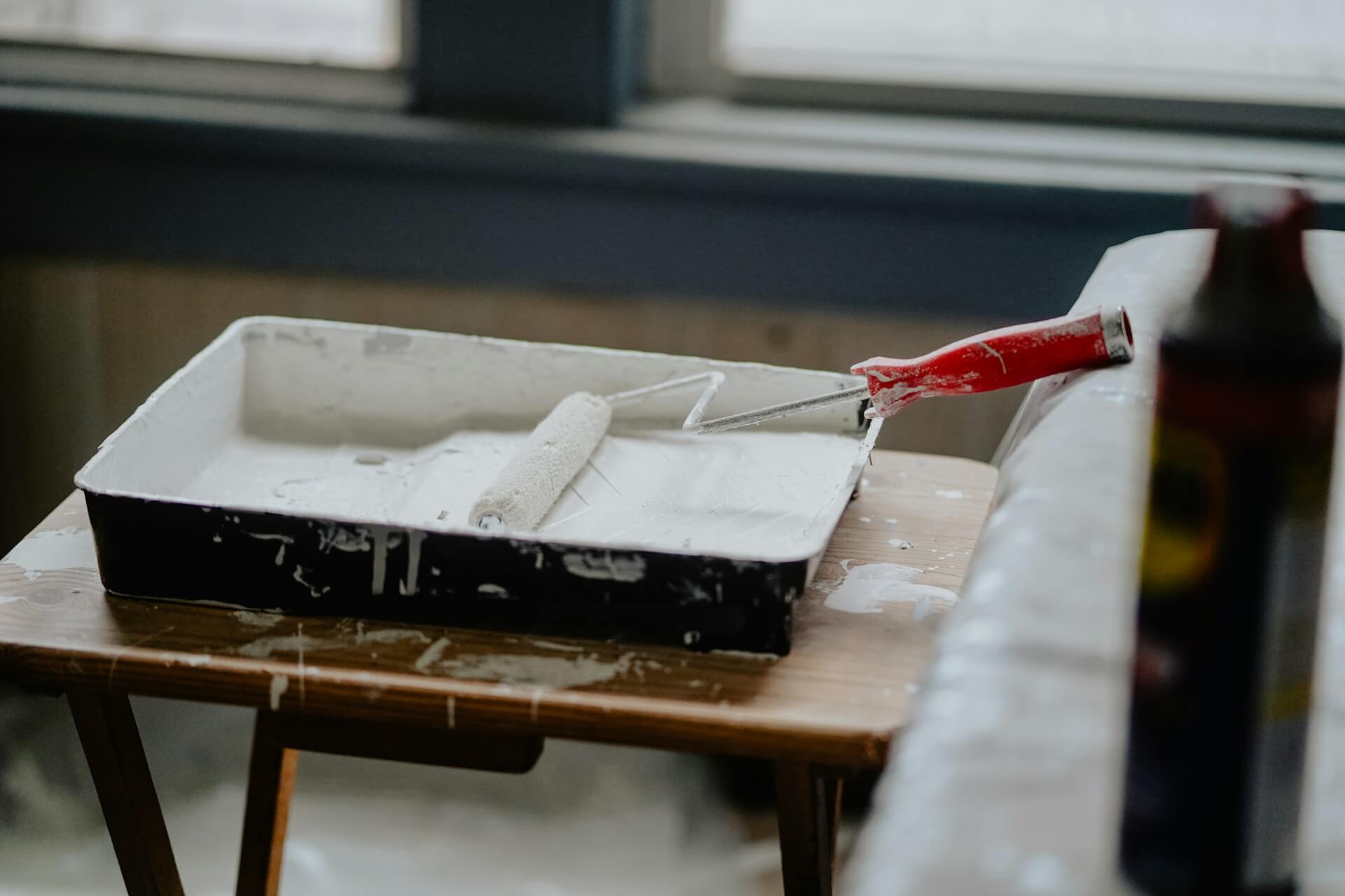 Paint brush on a white paint home interior