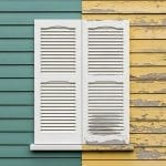 House exterior siding showing heavy peeling and flaking paint alongside fresh paint, illustrating the signs it's time to repaint your exterior in Cranston