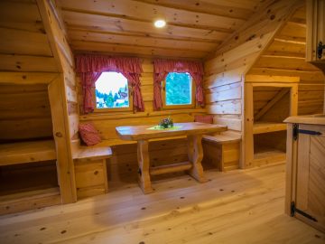 A painted wooden table in a log cabin.